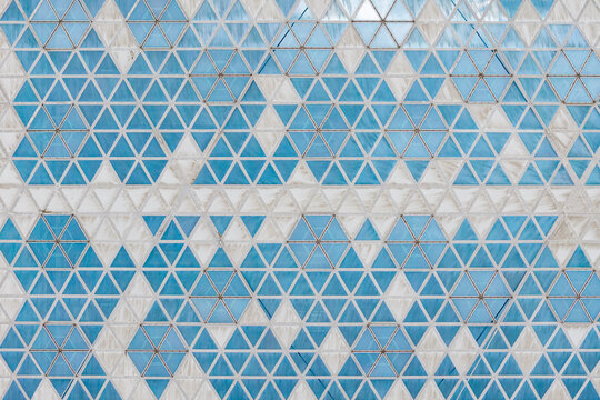 Aerial view of the geometric glass facade of the Lodz Fabryczna station featuring blue triangular panels and white structural elements in Lodz, Wojewodztwo lodzkie, Poland.