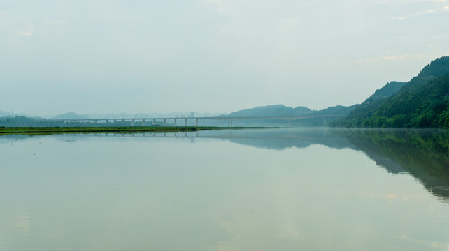 Tranquil River and Bridge with Mountain Reflections in Pengan County, Sichuan, China