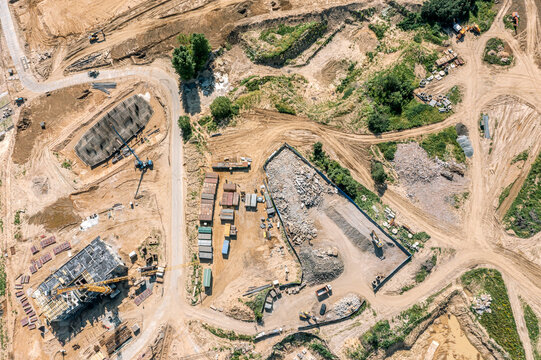 aerial view of large construction site with machinery, equipment and materials. early stage of construction.