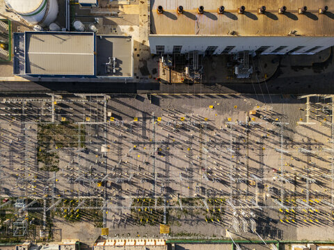 Aerial view of the thermoelectric power plant featuring complex electrical infrastructure, transformers, and industrial buildings in Merida, Yucatan, Mexico.