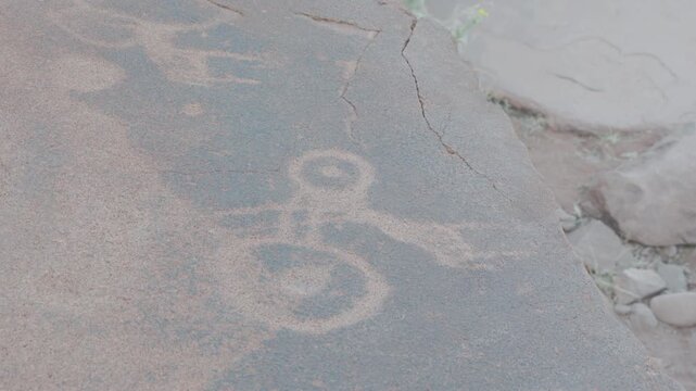 a tilt up clip of a rock carving of a symbol at twyfelfontein in namibia, africa