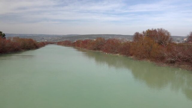 Loire River in France, panoramic waters with calm green surface and distant shoreline.