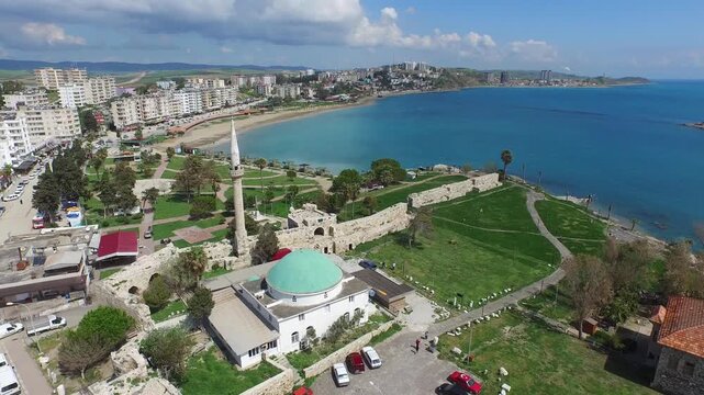 Aerial view captures a coastal mosque with turquoise dome in Yumurtalik, Adana, Turkey.