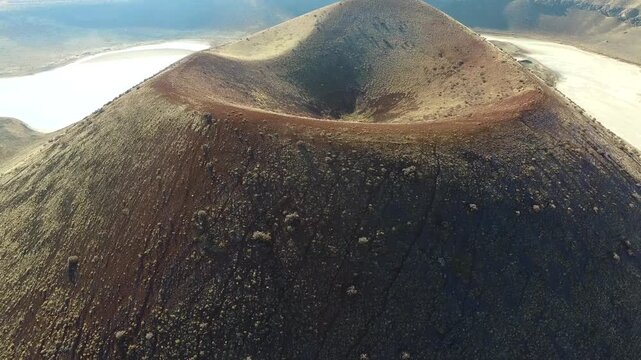 Konya Turkey volcanic crater lake sits inside a barren caldera with tuff ring cone.