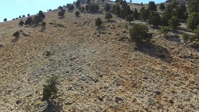 Aerial drone Kizlarsivrisi Mountain with spring dome peak with patchy snow above Elmali region.