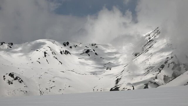 Caucasus snowy mountain peaks and rugged ranges show cold winter scenery above alpine valleys.