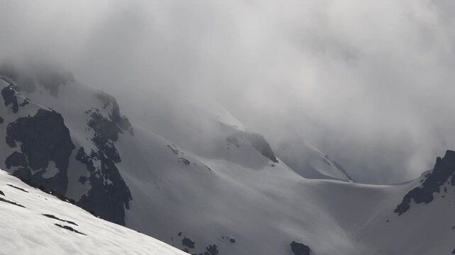 Caucasus snowy mountain peaks and rugged ranges show cold winter scenery above alpine valleys.
