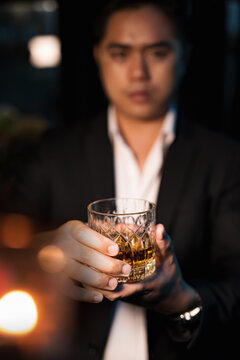 Closeup businessmen holding a glass of whiskey