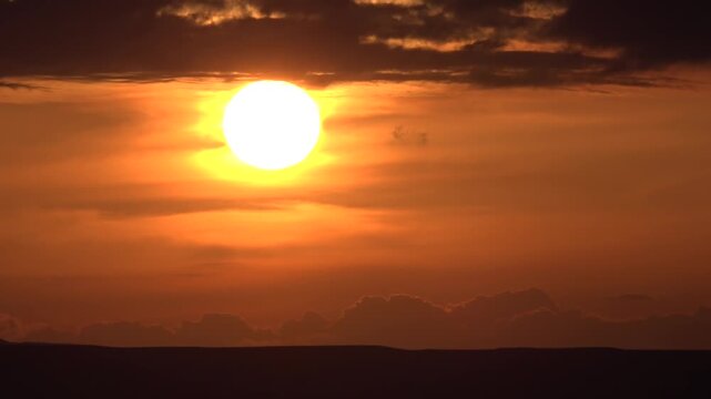 Red sun dusk above Libya cloud layers fiery evening glow evening weather detail.