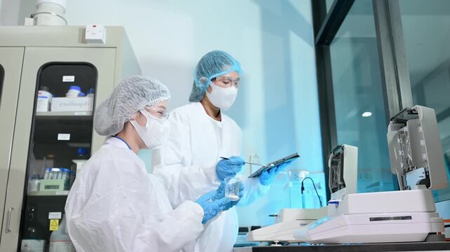 Scientist team meeting and writing analysis results in the laboratory study and analyze scientific sample