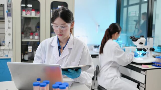 Scientist team meeting and writing analysis results in the laboratory study and analyze scientific sample