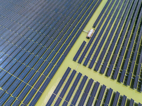 Aerial view of the Sirajganj 68MW Solar Park with rows of photovoltaic panels installed over water in Sirajganj, Rajshahi Division, Bangladesh.
