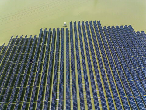 Aerial view of Sirajganj 68 MW Solar Park with rows of floating solar panels installed on the water surface Sirajganj, Rajshahi Division, Bangladesh.