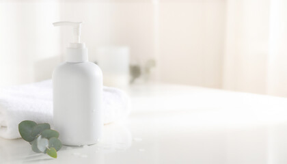 Fototapeta premium Minimal White Pump Bottle with Towels and Eucalyptus, Skincare Packaging Mockup with Copy Space