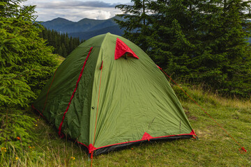 Camping in the Carpathians with a tent in the valley near Kukul © mykhailo