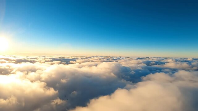 Soft white fluffy clouds floating slowly through a bright light blue sky in an aerial panoramic view creating a dreamy atmosphere