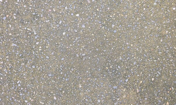 Exposed aggregate concrete floor texture for outdoor walkway. Top view of seamless washed gravel concrete pavement, showcasing detailed small pebble stone texture.