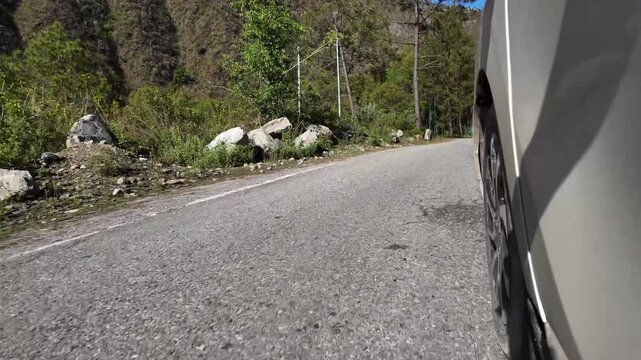 Exterior Front Left Tire POV Navigating Scenic Asphalt Highway In Lower Himalayas