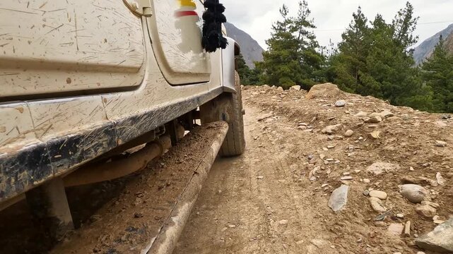 Extreme Low Angle POV Of Muddy 4x4 Vehicle Driving On Rocky Himalayan Dirt Track