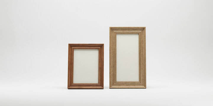 Two empty wooden frames of different sizes standing on white background