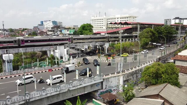 Malioboro, Jogja, with its busy street and the sight of a passing train.