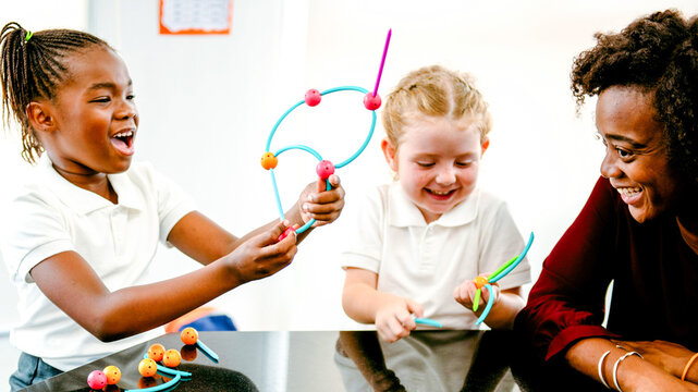 Joyful children learning with creative toys in classroom
