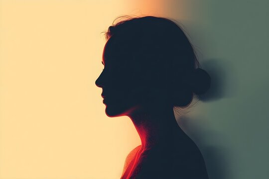 Woman's silhouette profile lit by orange and teal gel light