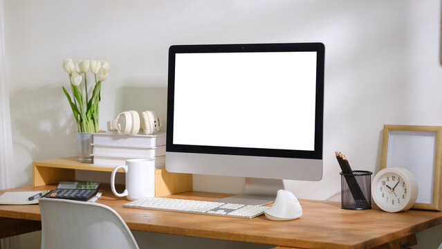 Blank computer screen displayed on a modern workspace desk for a digital mockup.