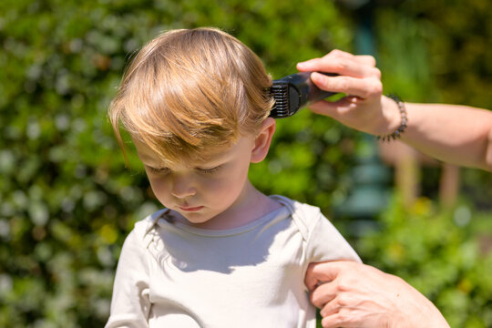Toddler Receiving Outdoor Summer Haircut