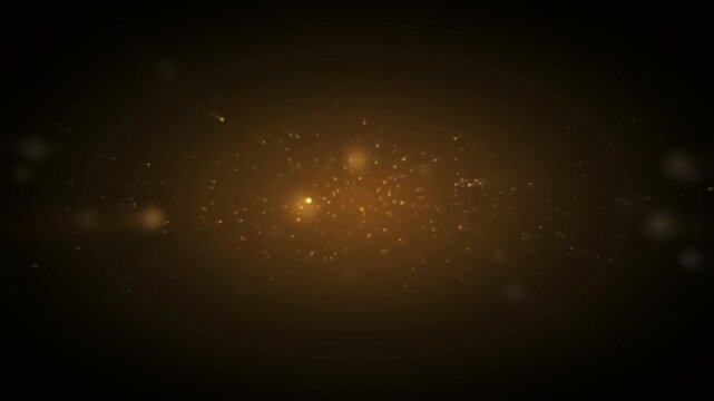 Golden glowing particles and shimmering dust on a black background for luxury cinematic effects