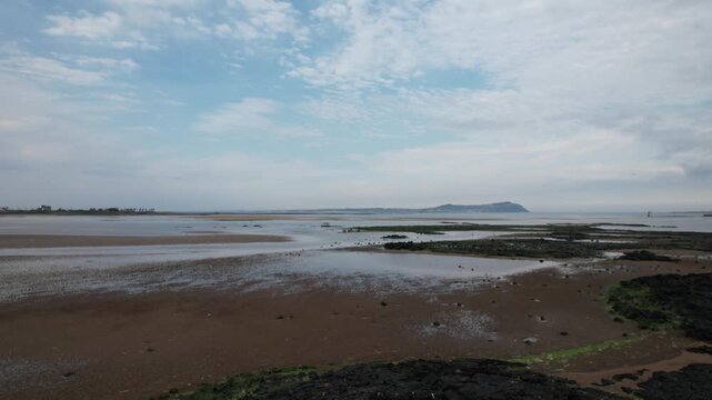 Aerial drone footage of the tidal mudflat at Jageun Hado Beach, Jeju Island, South Korea.