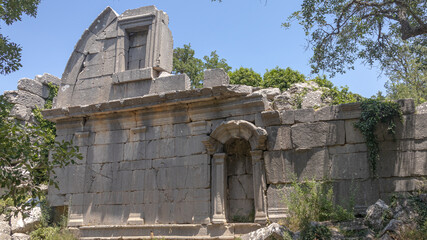 Fototapeta premium The ruins of Termessos. An ancient megalithic structure in Turkey. Ancient buildings of previous civilizations. Arches made of megalithic stone blocks.