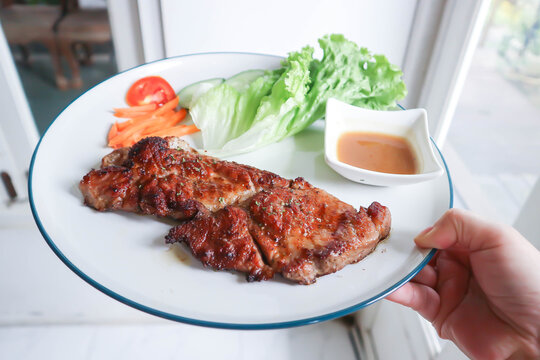 pork steak or grilled pork and salad or pork chop and vegetable
