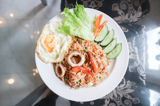 fried rice or stir-fried rice with shrimp , squid and fried egg or sunny side up egg