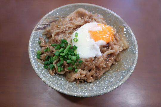 Rice topped with stir fried pork or stir fried beef and egg or Japanese food or Korean food or Beef Rice Bowl , Gyudon
