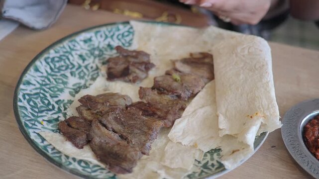 Eating grilled meat with bread in a restaurant