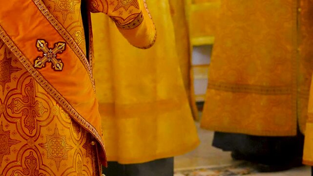 Priests swinging a golden censer in church.