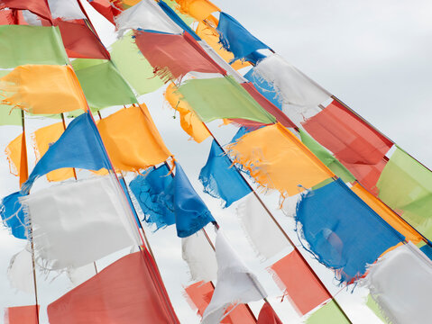 Colorful prayer flags fluttering in wind on Inner Mongolia grassland