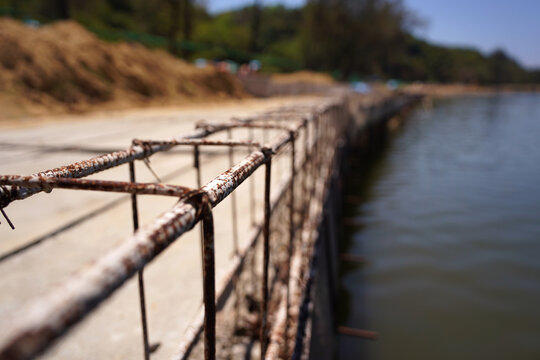 Building process city levee. Exposed foundation rebar grid at site, standing formwork and concrete footings