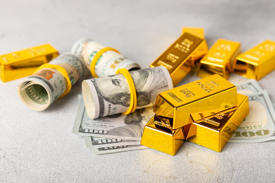 Gold bars, gold nuggets and US dollar banknotes. gold bullion and precious metals representing wealth, investment, financial security, savings, prosperity, luxury, capital, banking and global finance.