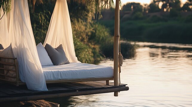 daybed. A lavish daybed with sheer fabric on a riverbank at sunset, warm golden hour light, serene. inspiring travel planning.