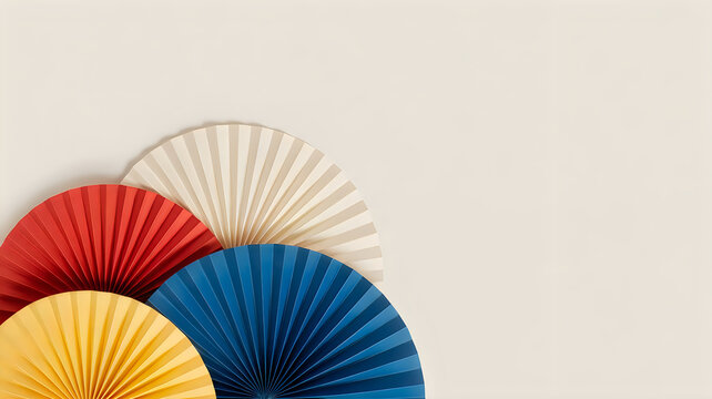 Colorful paper hand fans in red, blue, yellow and white
