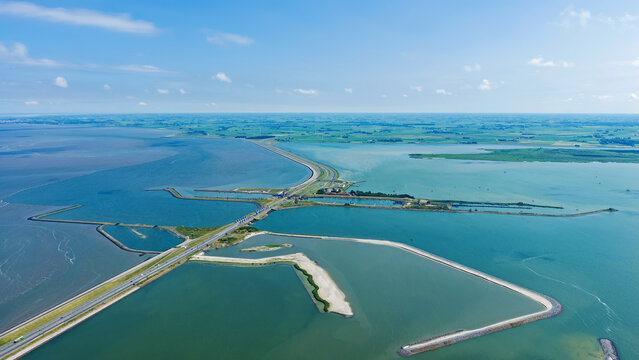 Aerial view of the Vismigratierivier fish migration river and the Afsluitdijk causeway separating the Wadden Sea and IJsselmeer in Kornwerderzand, Friesland, Netherlands.
