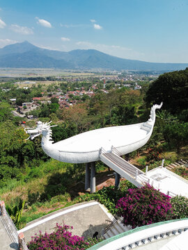 Aerial view of the Eling Bening dragon-shaped viewing platform surrounded by lush greenery and mountains in Semarang, Jawa Tengah, Indonesia.
