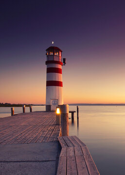 very amazing moments at the sunset near the lighthouse by the sea
