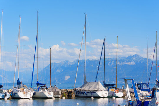 Morges, Switzerland - August 6, 2026: Sailboats Moored at Morges Marina on Lake Geneva with Alps Background