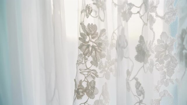 White Lace Curtain or Wedding Dress Fabric Swaying in Soft Light Background.