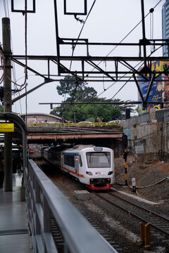Jakarta, Indonesia - August 9, 2026: KAI Bandara EA203 Series airport train passes beneath the Sudirman Street bridge.
