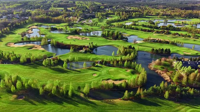 Golf course with multiple ponds and manicured grass