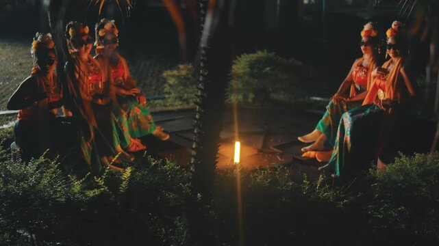 Groups of Traditional Dancers with Sunglasses Relaxing Outdoors at Night